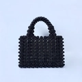 Detailed view of handmade black beaded evening bag with textured pearl bead patterns - Black