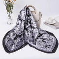 Classic black and white paisley satin scarf draped on a white handbag in a lifestyle setting - 90*90cm / Black Paisley