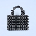 Front detail of handmade metallic grey beaded handbag with shiny woven texture - Graphite