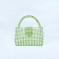 Detail view of handmade green acrylic beaded tote bag featuring a subtle heart pattern weave - Light Green