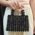 Handcrafted black beaded handbag with colorful accents and vintage-style top handle - Black + Multi-color