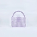Macro detail of handmade lavender acrylic beads on a mini woven top handle square bag - Light Purple