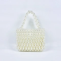 Dettaglio macro della borsa a mano in perle intrecciate con trama elegante - Bianco latte