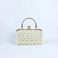 Detailed view of white faux pearls on evening bag with an ornate golden metal handle - Pearl White