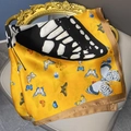 Artistic yellow silk scarf with butterfly print draped on a vintage gold frame - Yellow
