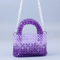 Detail of purple gradient acrylic beaded bag with handmade weave and clear chain - Purple