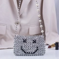 Handwoven silver beaded crossbody bag with a black smiley face and pearl strap details - Silver + Black