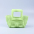 Detailed macro of mint green acrylic beaded weaving and square handle on a handbag - Yellow-Green