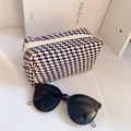 Detail of houndstooth fabric makeup bag with white zipper and black sunglasses - 18*10 / Black and White