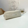 Detail of off-white canvas pencil case featuring a ruler label and large capacity storage - Beige