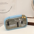 Detail of light blue PU pencil case featuring a black mesh window and dual gold zippers - Sky Blue