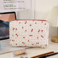 Dettaglio della borsa per trucco trapuntata con zip rossa e motivo floreale retrò - Rosso (Grande)
