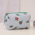 Detail of floral quilted cosmetic bag featuring blue grids and a green zipper - Emerald Green Makeup Bag