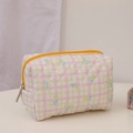 Close-up of quilted floral cosmetic bag with yellow zipper and pastel plaid pattern - Lemon Yellow Makeup Bag