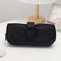 Detail of a black cylindrical pencil case featuring a heavy-duty buckle strap and zipper - Black