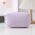 Detail of lavender checkerboard pencil case with woven texture and zipper closure - Purple