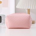 Close-up of pink checkered pencil case with soft fabric texture and zipper closure - Pink