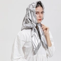 Silver-grey satin square scarf with abstract patterns worn as a stylish headscarf - S162 Gray