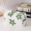 Detailed macro view of plush white stationery pouch with green floral embroidery and zipper - Green Flower