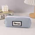 Detailed view of Morandi blue dachshund pencil case with ring zipper and woven texture - Beige Large Label Puppy Pencil Case