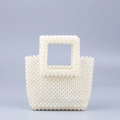 Elegant white faux pearl woven handbag featuring a minimalist top-handle square design - White