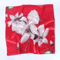 Detail of red satin scarf showing white magnolia print and smooth silk texture - Red with Freehand Magnolia