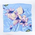 Detail of blue satin silk scarf showing floral orchid print and smooth glossy texture - Sky Blue with Purple Flower