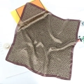 Detail of leopard print silk scarf with satin edges and premium orange gift box - Green