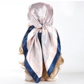 90cm light pink silk scarf with geometric patterns and navy border on a headpiece model - Geometric Pink Blue