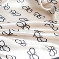 Detailed close-up of butterfly print satin scarf fabric with elegant silk texture - Khaki Butterfly