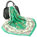 Close-up of a floral satin scarf with lily of the valley pattern draped over a handbag - 90x90cm / 16# Green Harebell