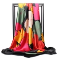 Silk satin scarf with vibrant floral leaf prints displayed on a black metal rack - 90x90cm / Black