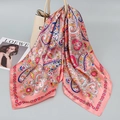 Pink satin square scarf with paisley floral pattern draped over a white handbag - Pink Paisley