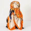 90cm satin square scarf featuring orange and peacock blue feather prints worn as a headscarf - 90x90cm / Orange Peacock