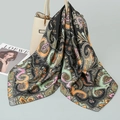 Silky satin square scarf with vintage paisley pattern draped on a beige handbag - Black Orange Paisley