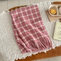 Detail view of pink and white plaid scarf with soft fringe edges on a cozy background - Dusky Pink