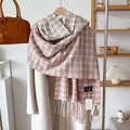 Pink and beige plaid scarf with tassels styled on a wool coat for autumn winter fashion - Pink