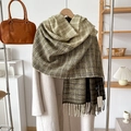 Detail of plaid scarf with tassels in olive green and brown tones on beige coat - Green