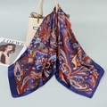 Blue paisley satin silk scarf draped on a handbag showing vibrant patterns - Purple Paisley