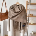 Classic British plaid cashmere-like scarf with tassels over white wool coat - Flax Khaki