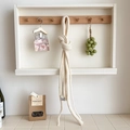 Minimalist cream knit wool baguette scarf hanging on a wooden hook in a warm setting - Off White