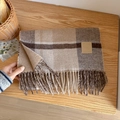 Plaid wool scarf with fringe and leather patch in brown tones on a wooden table - 33x190cm / Coffee Camel