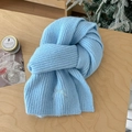 Detail of light blue wool blend scarf with embroidered bow on a cozy winter setting - Sky Blue