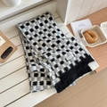 Winter plaid knitted scarf in black and white checkers on a rustic wooden bench - Black & Gray Plaid