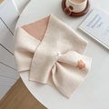 Elegant cream knitted scarf with orange flower embroidery on a warm cozy table - White