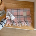 Pink and grey plaid wool scarf with fringe trim and leather logo patch on wood surface - 33x190cm / Pink