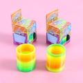 Set of colorful gradient rainbow spring toys with cartoon packaging on pink background - Small Size (Approx. 6x5cm)