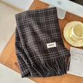 Detail of dark coffee plaid scarf featuring thick tassels and a woven white brand label - 196cmx65cm / Dark Coffee