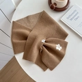 Warm brown knitted cross scarf with white flower detail and soft autumn texture - Mocha