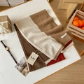 Macro detail of 100% Australian wool scarf featuring tri-color patchwork and brand label - 135-175CM / Rice Camel
